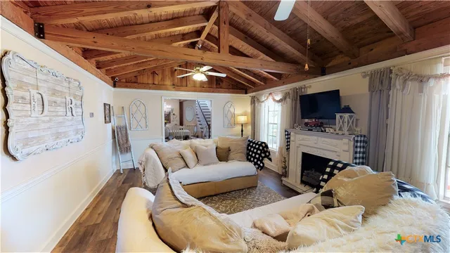 a living room with furniture a fireplace and a flat screen tv