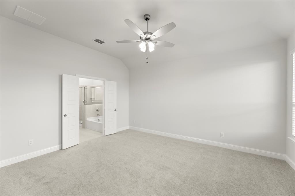 125 Meadow Road Balch Springs, TX 75181 - Photo 17 of 27 a view of an empty room with a ceiling fan