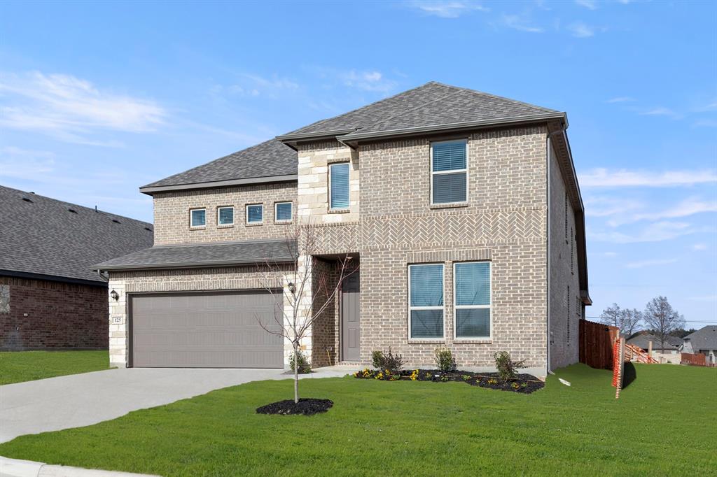 125 Meadow Road Balch Springs, TX 75181 - Photo 2 of 27 a front view of a house with a garden and yard