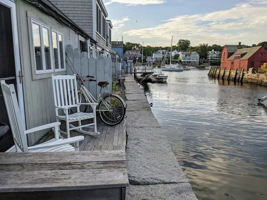 6 Tuna Wharf, Unit 2021 Rockport, MA 01966 - Photo 1 of 20 a view of roof deck with dining table and chairs