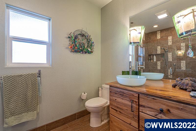 1569 Briar Road Independence, OR 97351 - Photo 11 of 24 a bathroom with a granite countertop sink a toilet and a mirror
