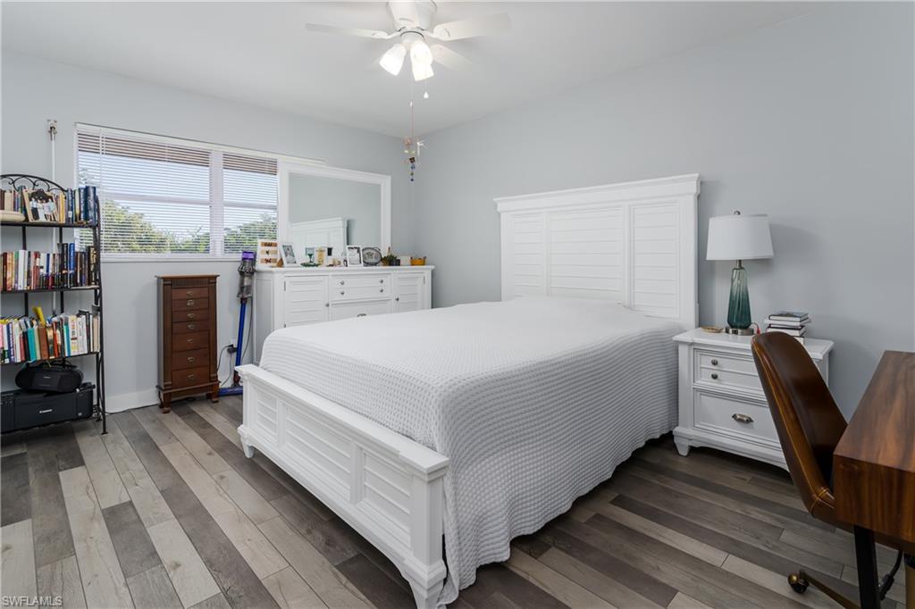 5499 Rattlesnake Hammock Road, Unit 304A Naples, FL 34113 - Photo 15 of 38 a bedroom with a bed and a chair