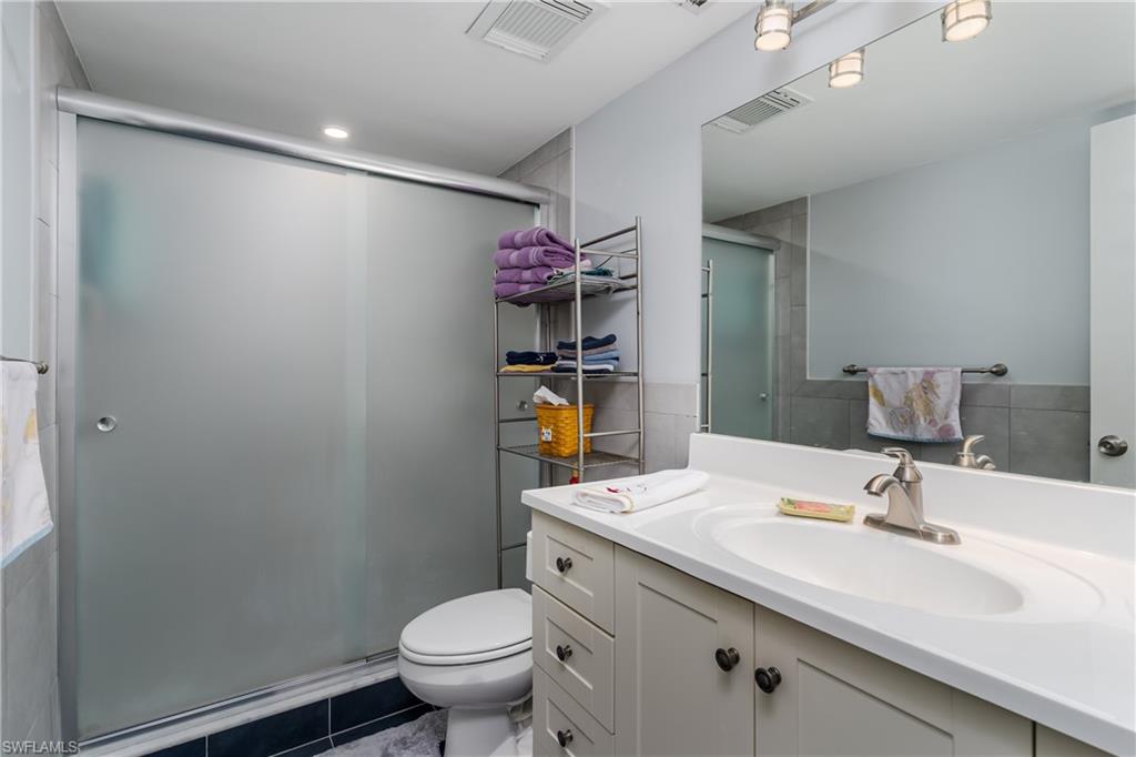 5499 Rattlesnake Hammock Road, Unit 304A Naples, FL 34113 - Photo 17 of 38 a bathroom with a sink mirror vanity and toilet