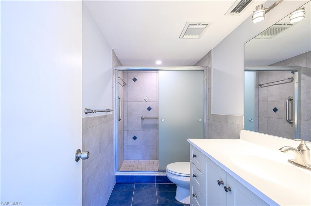 5499 Rattlesnake Hammock Road, Unit 304A Naples, FL 34113 - Photo 18 of 38 a bathroom with a sink a toilet and shower