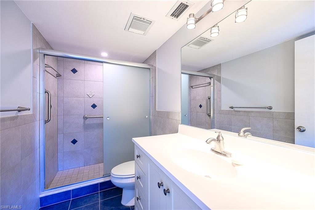 5499 Rattlesnake Hammock Road, Unit 304A Naples, FL 34113 - Photo 19 of 38 a bathroom with a sink a toilet and shower