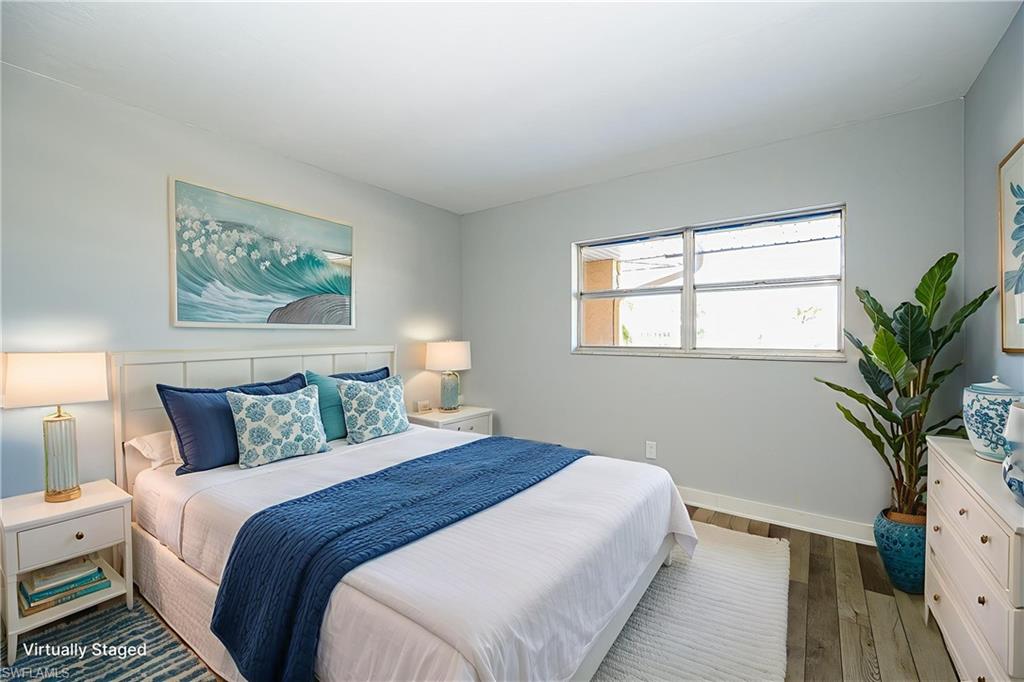 5499 Rattlesnake Hammock Road, Unit 304A Naples, FL 34113 - Photo 21 of 38 a bedroom with bed and a potted plant
