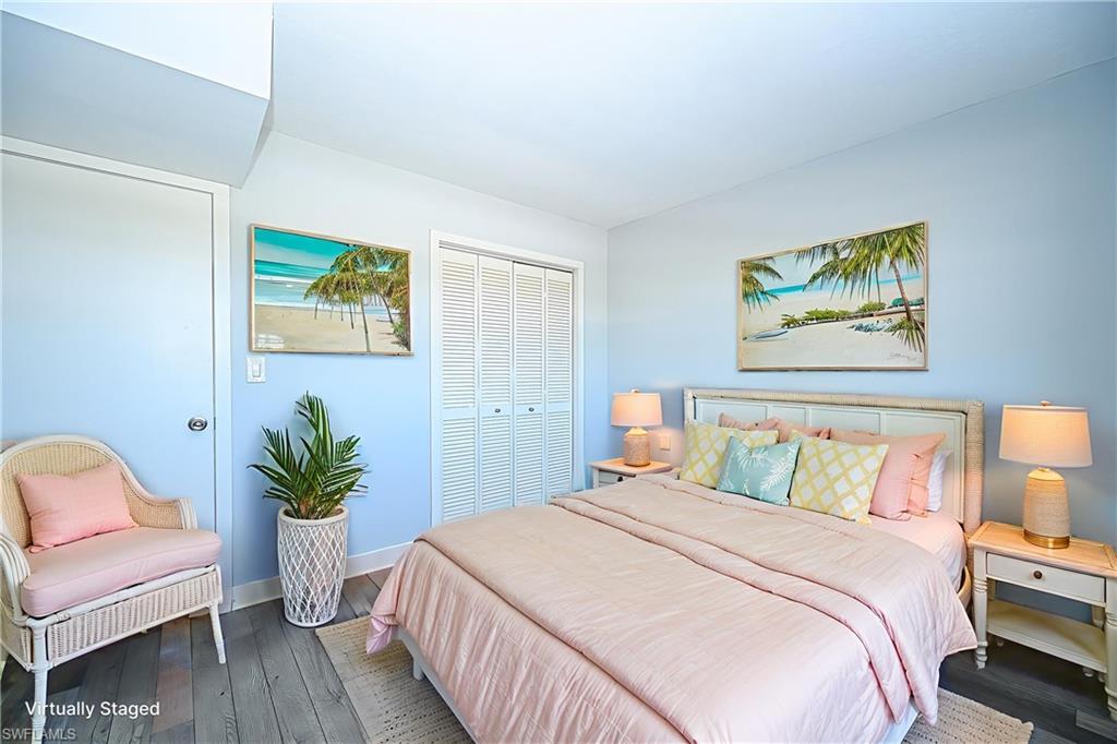 5499 Rattlesnake Hammock Road, Unit 304A Naples, FL 34113 - Photo 22 of 38 a bedroom with a bed and a painting on the wall