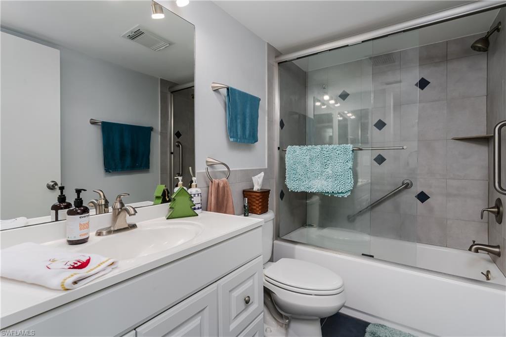 5499 Rattlesnake Hammock Road, Unit 304A Naples, FL 34113 - Photo 26 of 38 a bathroom with a sink toilet vanity and shower