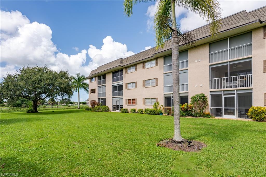 5499 Rattlesnake Hammock Road, Unit 304A Naples, FL 34113 - Photo 30 of 38 a front view of a building with a garden