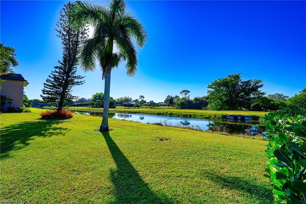 5499 Rattlesnake Hammock Road, Unit 304A Naples, FL 34113 - Photo 32 of 38 a view of a lake with a building in the background