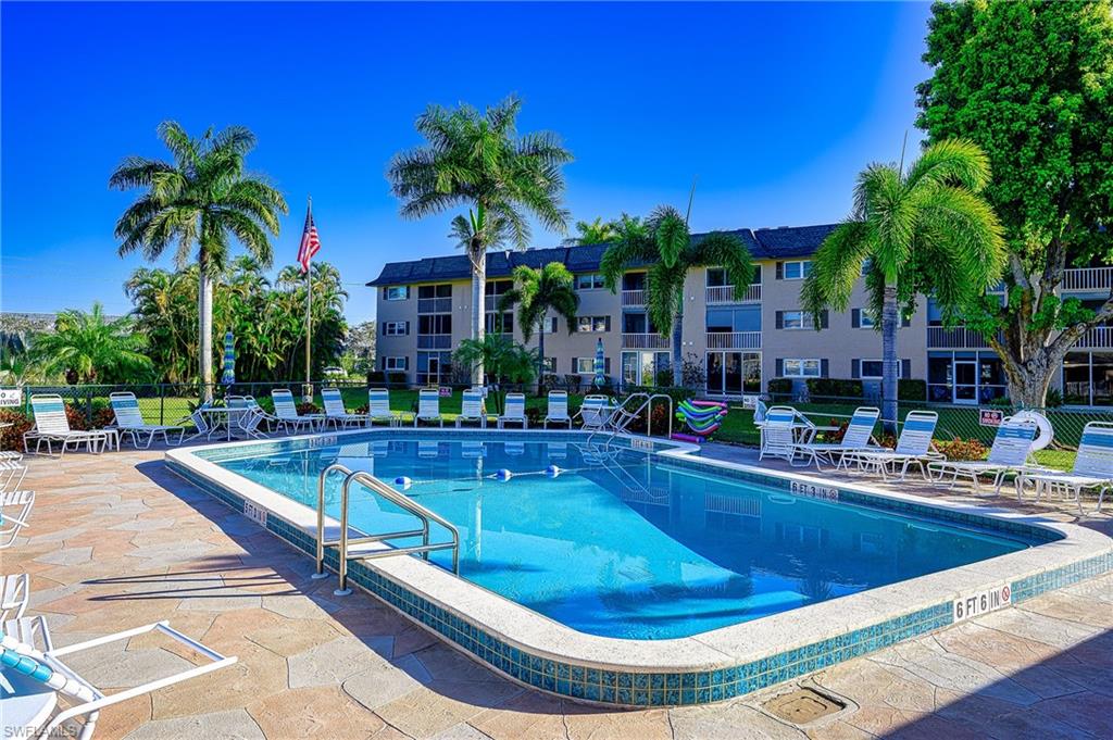 5499 Rattlesnake Hammock Road, Unit 304A Naples, FL 34113 - Photo 34 of 38 a view of a swimming pool with lounge chair