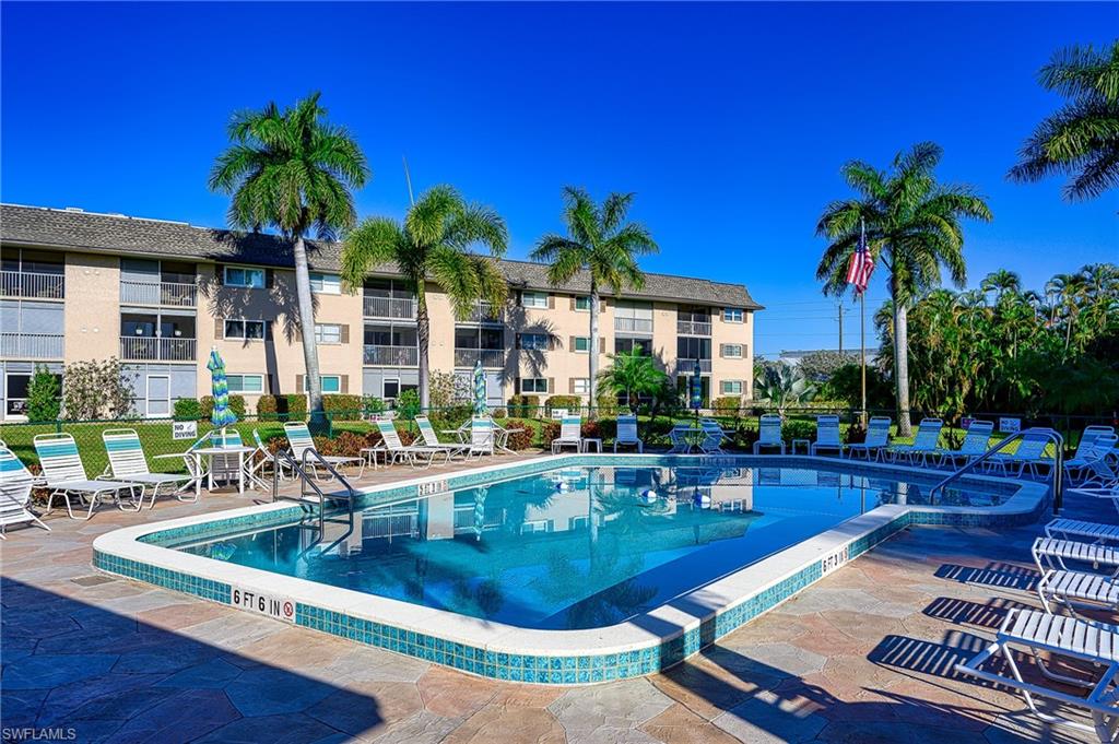 5499 Rattlesnake Hammock Road, Unit 304A Naples, FL 34113 - Photo 35 of 38 a view of a house with swimming pool and sitting area