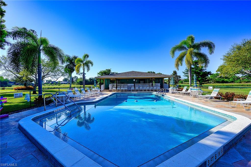 5499 Rattlesnake Hammock Road, Unit 304A Naples, FL 34113 - Photo 36 of 38 a swimming pool with outdoor seating