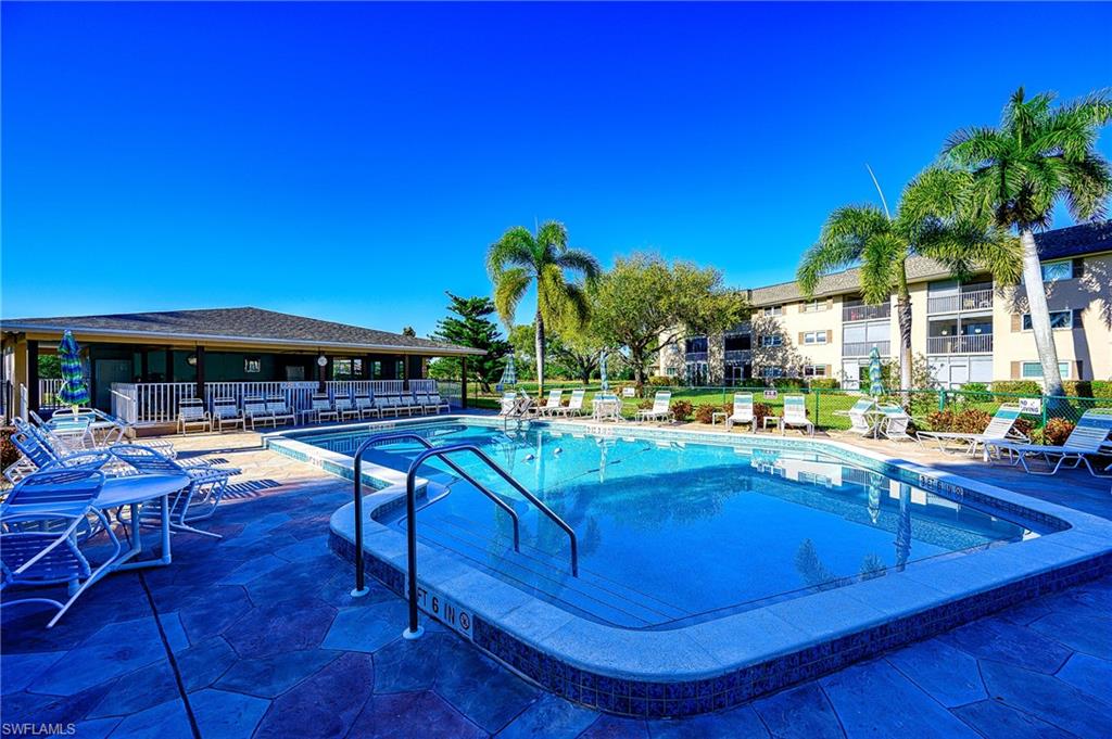 5499 Rattlesnake Hammock Road, Unit 304A Naples, FL 34113 - Photo 37 of 38 a view of swimming pool with outdoor seating