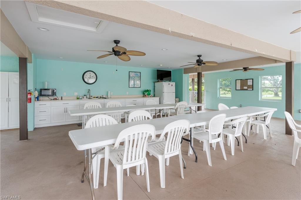 5499 Rattlesnake Hammock Road, Unit 304A Naples, FL 34113 - Photo 38 of 38 a view of a dining room with furniture and a clock