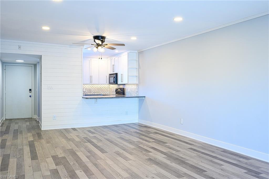 5499 Rattlesnake Hammock Road, Unit 304A Naples, FL 34113 - Photo 5 of 38 wooden floor in an empty room with a window