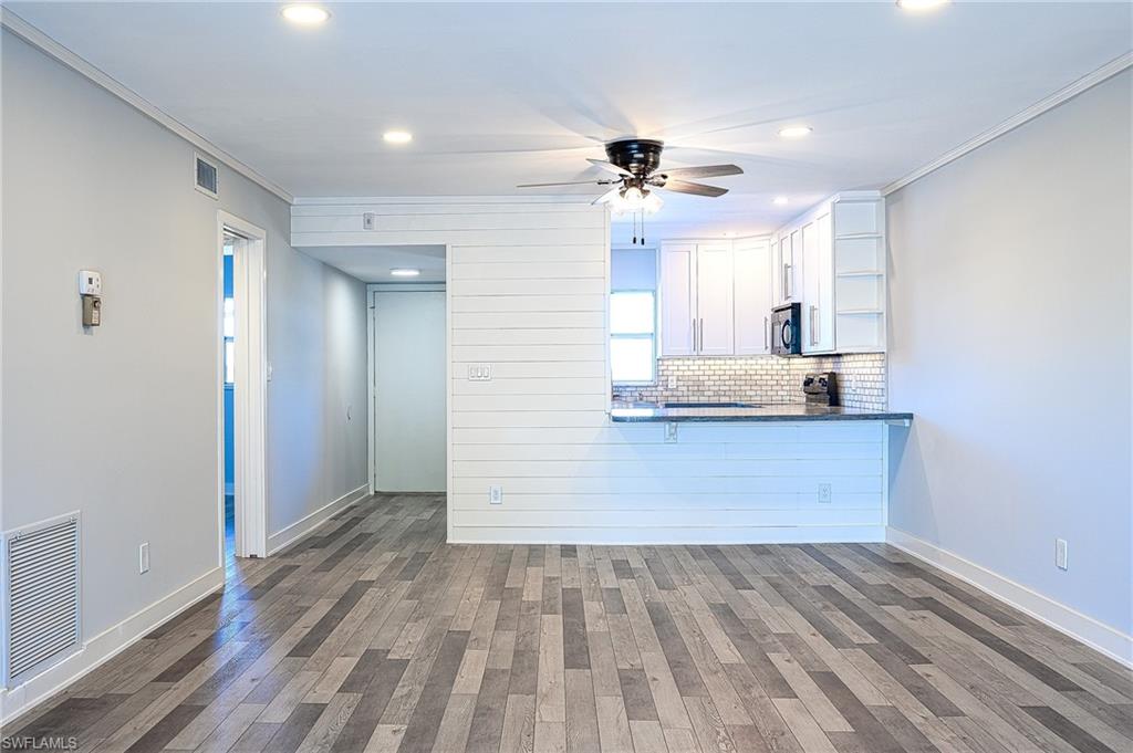 5499 Rattlesnake Hammock Road, Unit 304A Naples, FL 34113 - Photo 6 of 38 a view hallway with wooden floor and ceiling fan