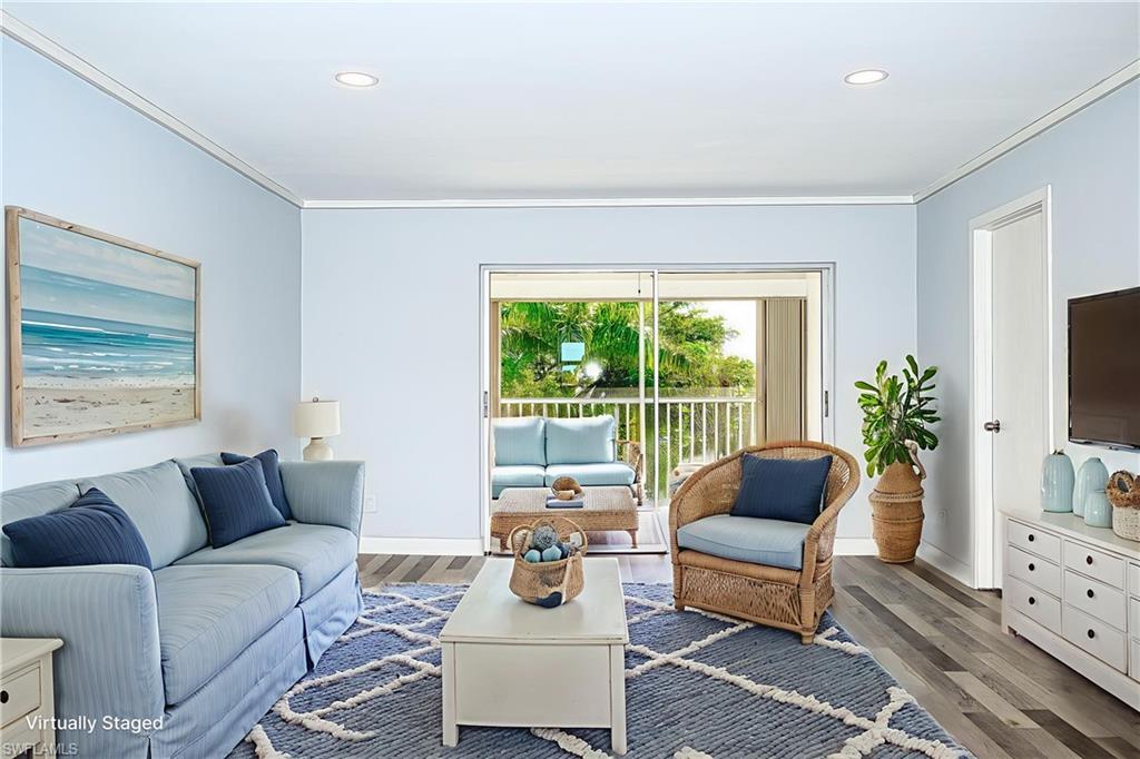 5499 Rattlesnake Hammock Road, Unit 304A Naples, FL 34113 - Photo 7 of 38 a living room with furniture and a flat screen tv
