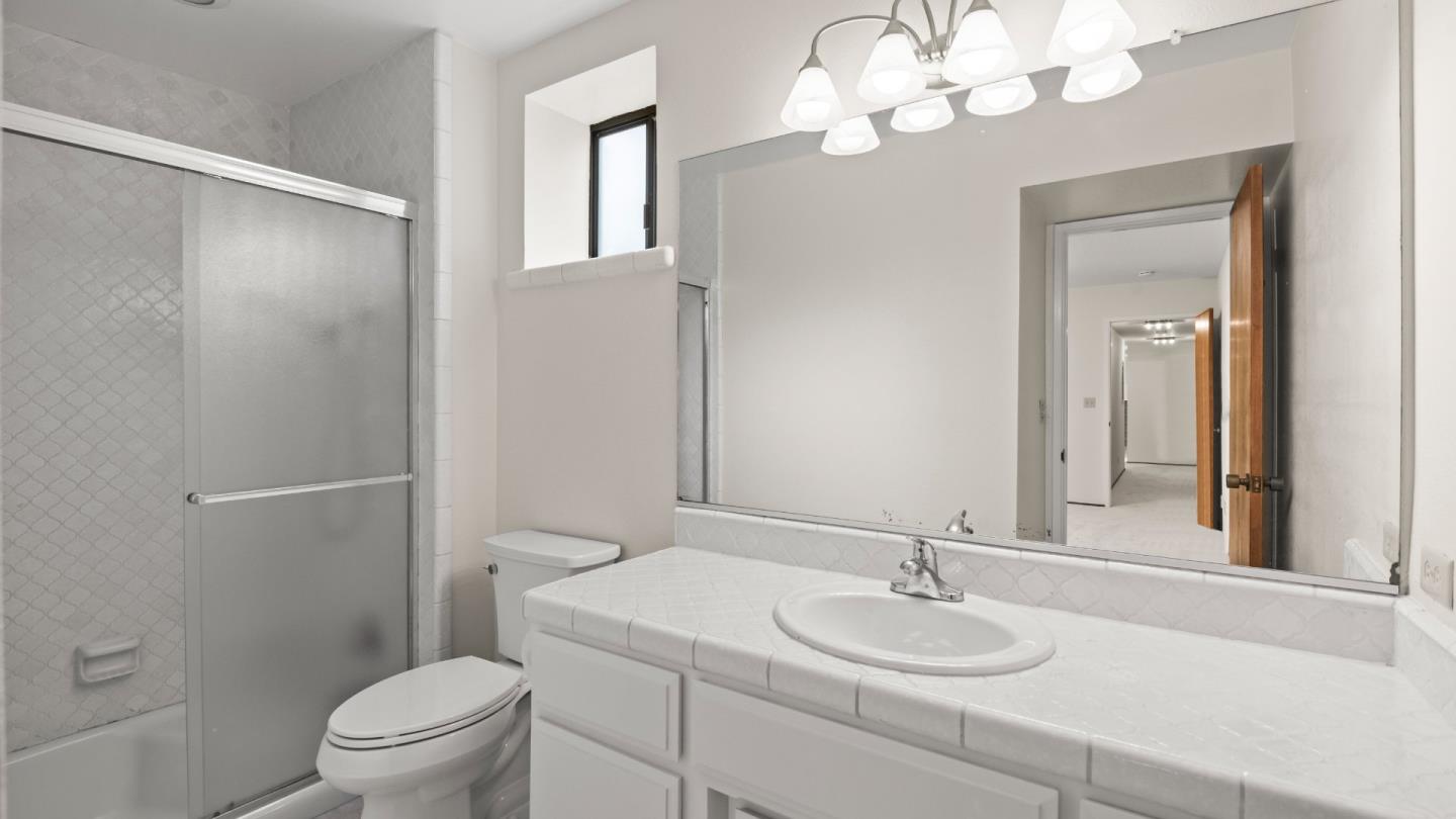 16353 Aztec Ridge Drive Los Gatos, CA 95030 - Photo 49 of 61 a bathroom with a granite countertop sink a toilet and a mirror