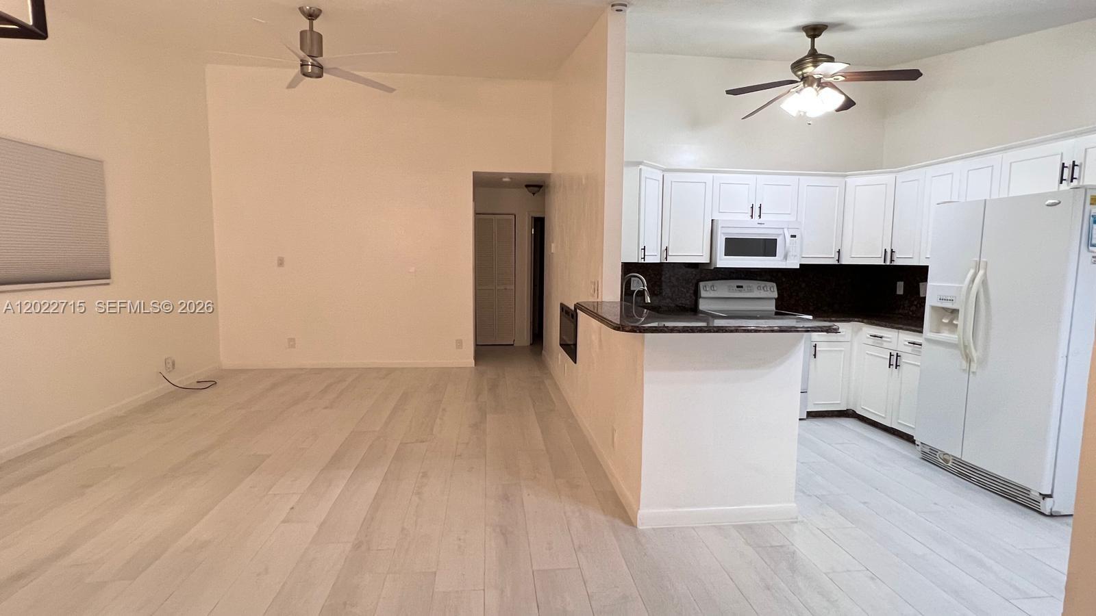 10669 Boca Entrada Boulevard Boca Raton, FL 33428 - Photo 8 of 19 a view of kitchen with sink microwave and refrigerator