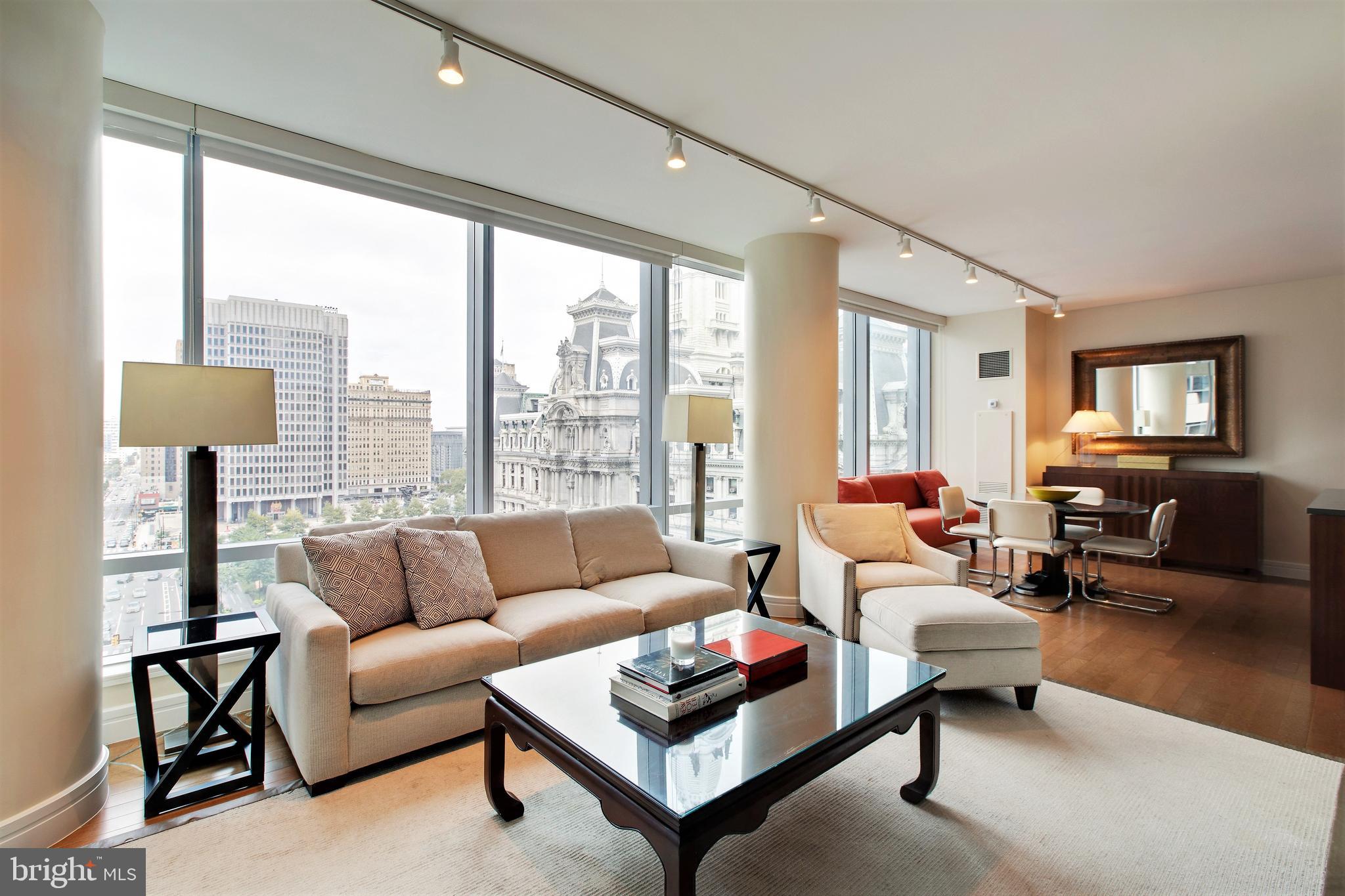 1414 South Penn Square, Unit 10F Philadelphia, PA 19102 - Photo 1 of 34 a living room with furniture and a large window