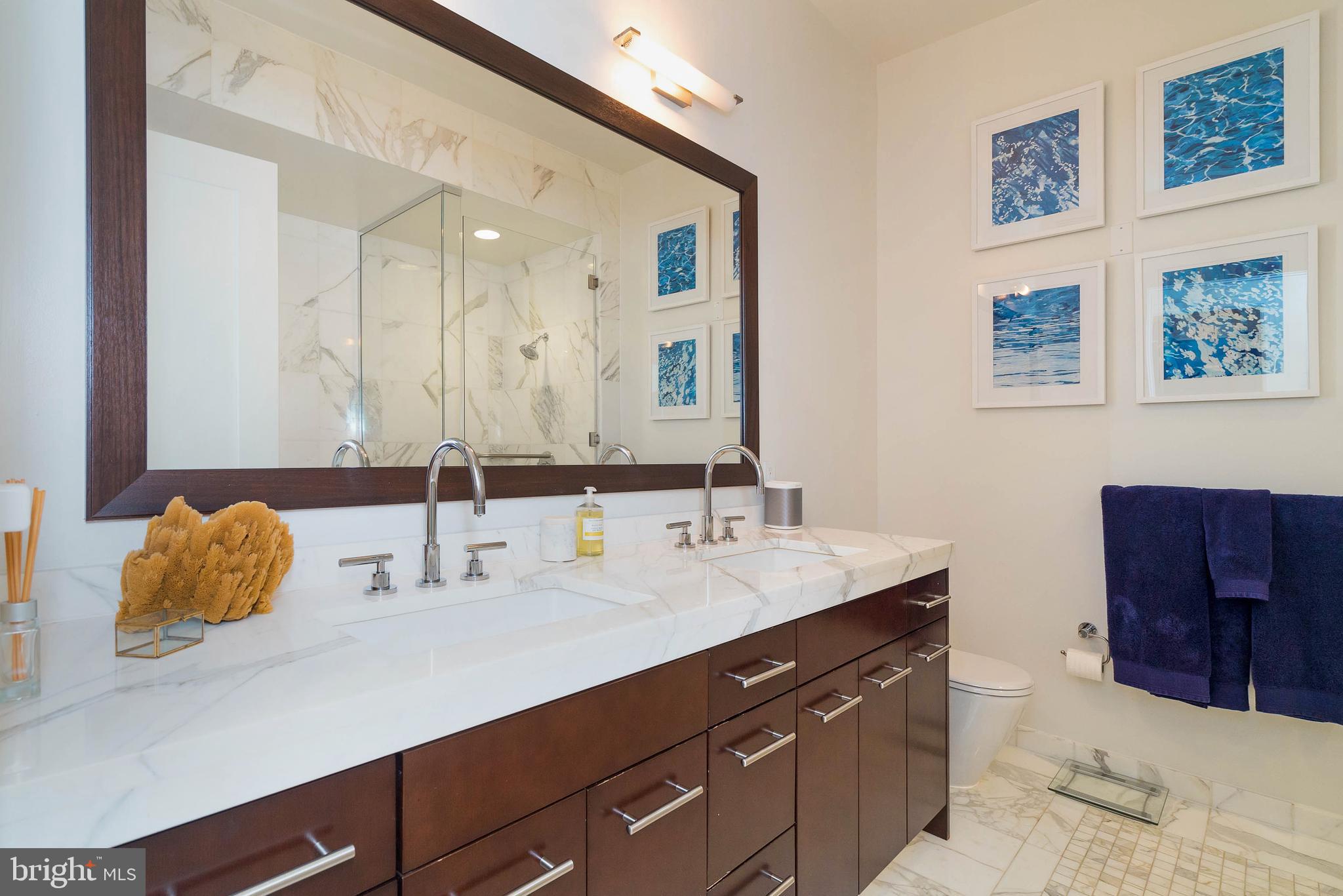 1414 South Penn Square, Unit 10F Philadelphia, PA 19102 - Photo 14 of 34 a bathroom with a sink double vanity and a mirror