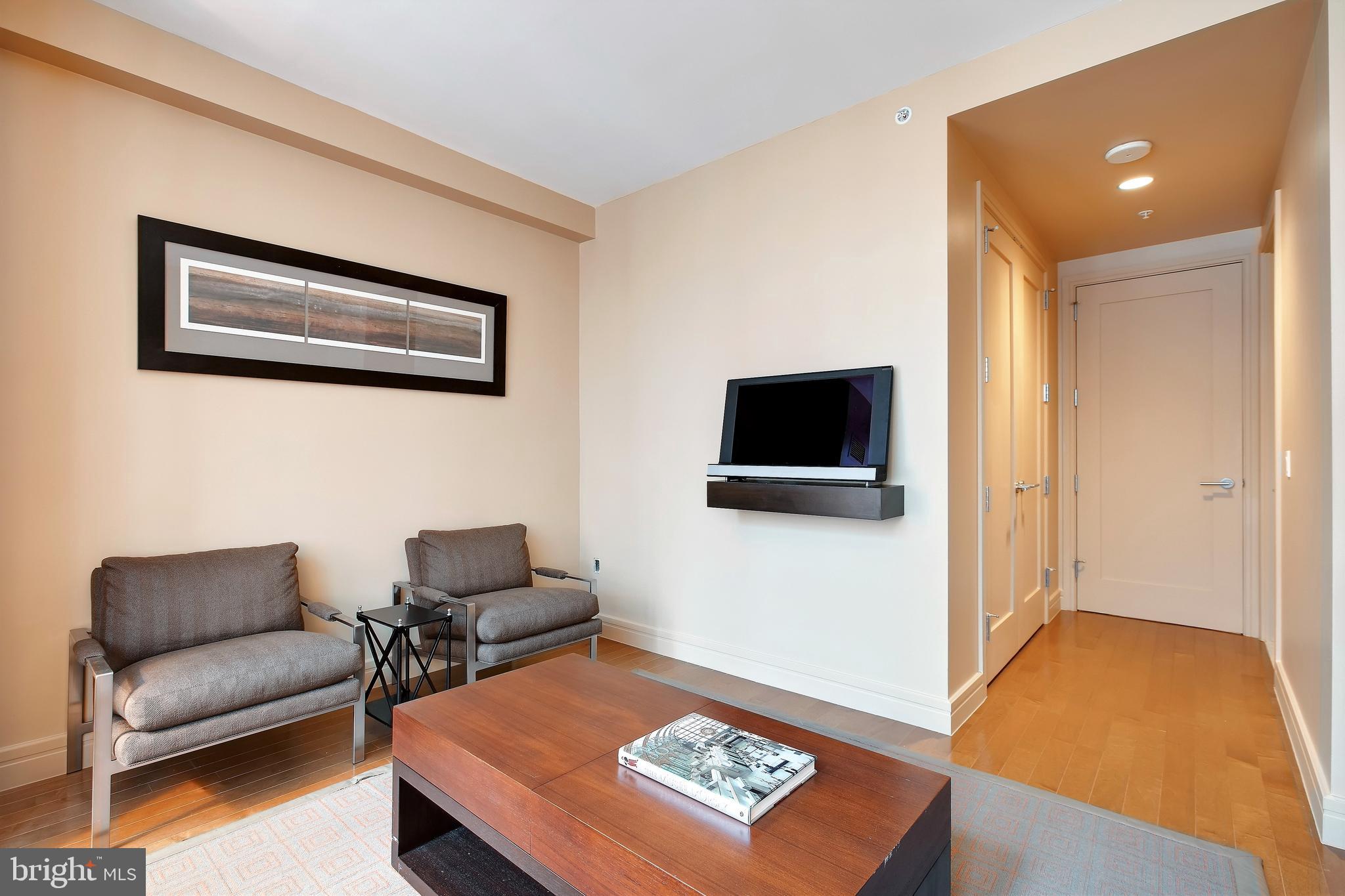 1414 South Penn Square, Unit 10F Philadelphia, PA 19102 - Photo 18 of 34 a living room with furniture and a flat screen tv