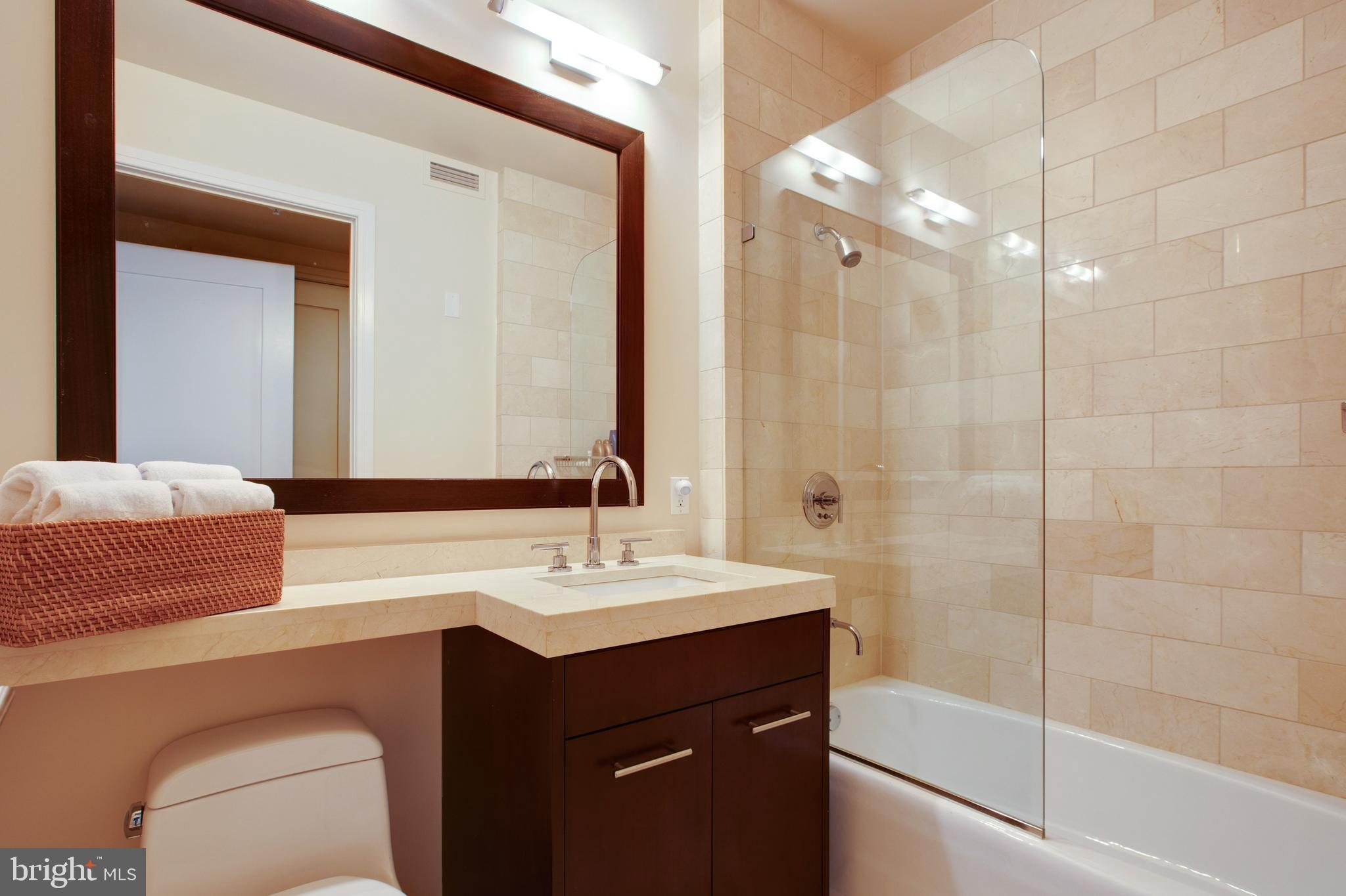 1414 South Penn Square, Unit 10F Philadelphia, PA 19102 - Photo 19 of 34 a bathroom with a double vanity sink mirror and bathtub