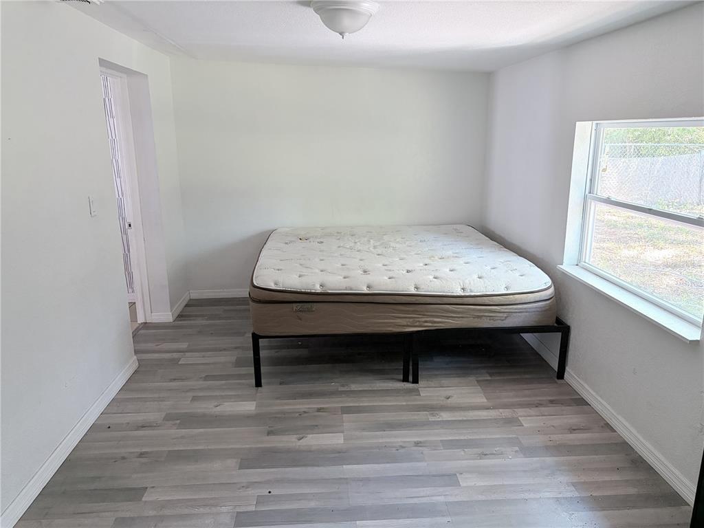 3818 Moog Road Holiday, FL 34691 - Photo 15 of 19 a view of bedroom with furniture and window