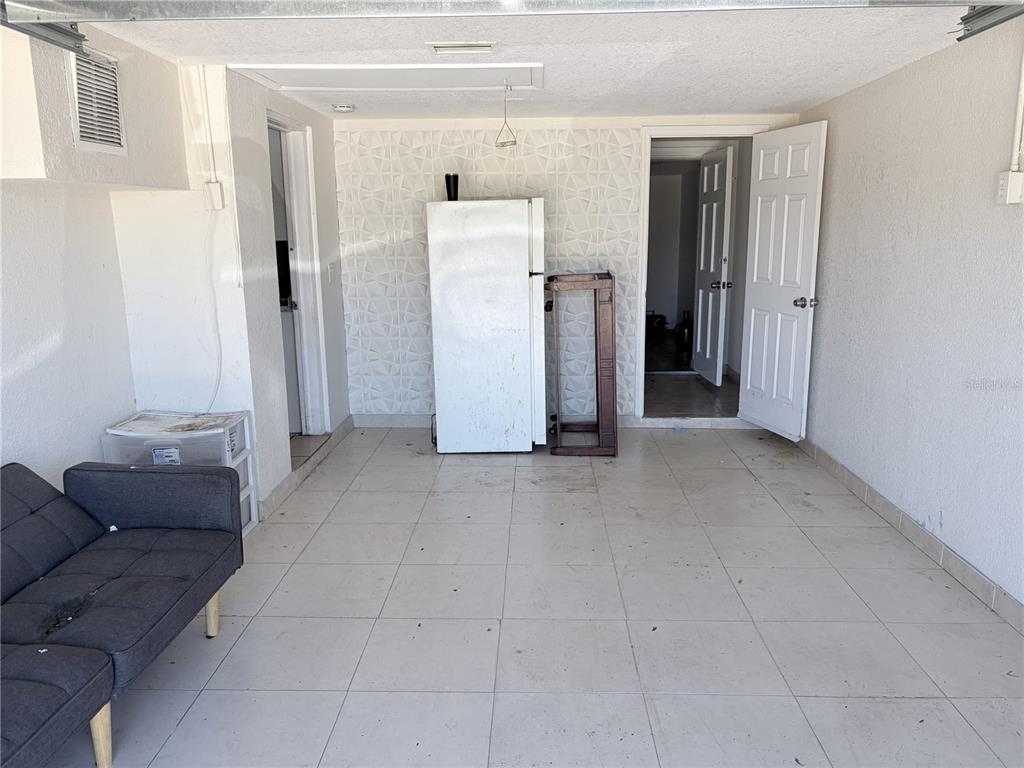 3818 Moog Road Holiday, FL 34691 - Photo 19 of 19 a view of a livingroom with furniture and refrigerator