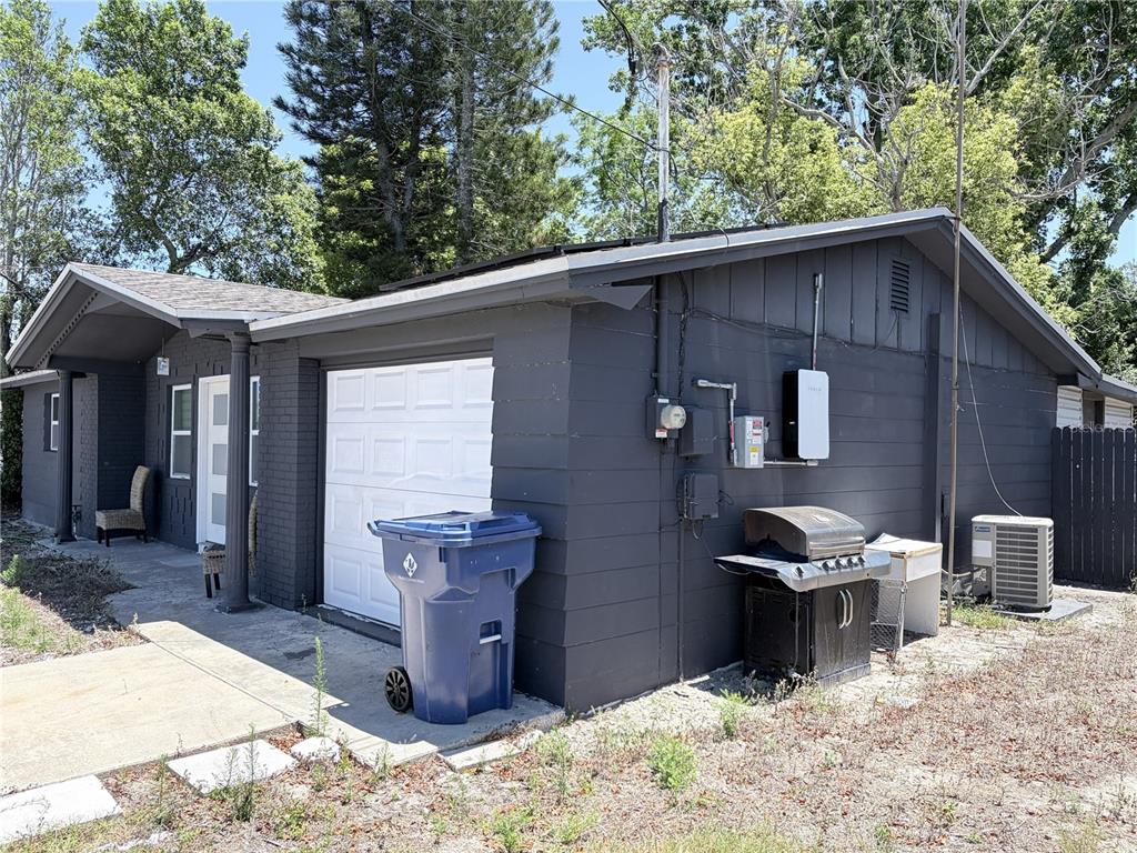 3818 Moog Road Holiday, FL 34691 - Photo 2 of 19 a backyard of a house with table and chairs
