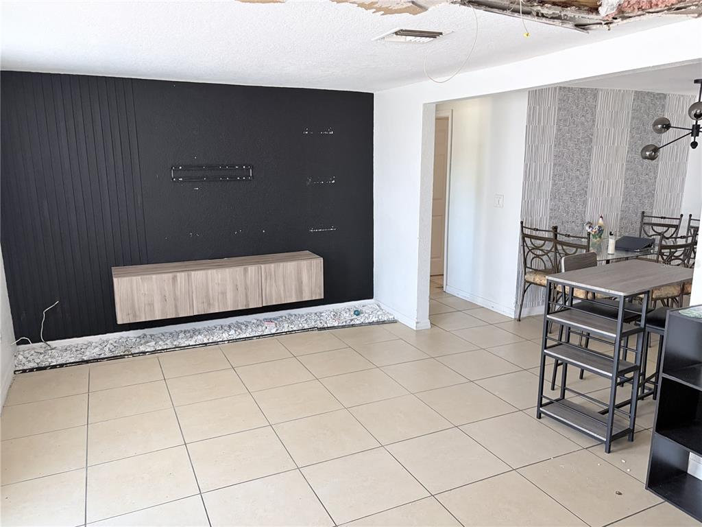 3818 Moog Road Holiday, FL 34691 - Photo 8 of 19 a living room with a sink and a table with rug