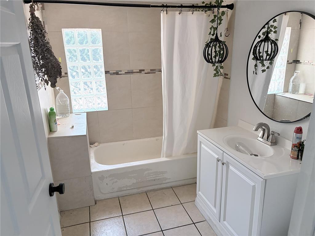 3818 Moog Road Holiday, FL 34691 - Photo 10 of 19 a bathroom with a sink a toilet and a mirror