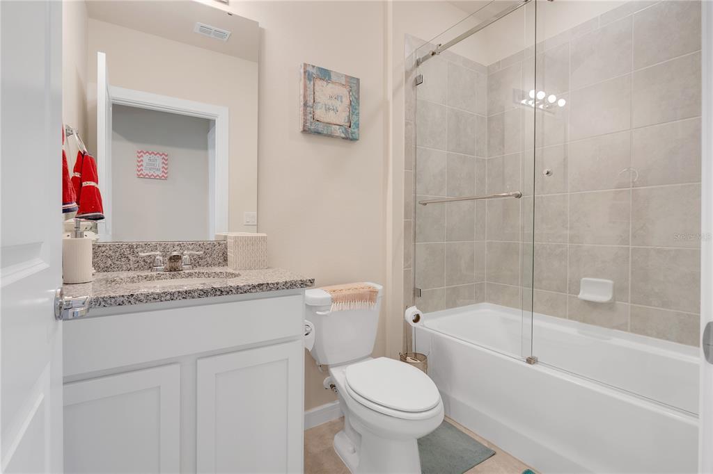 1001 Rivers Crossing Street Clermont, FL 34714 - Photo 16 of 41 a bathroom with a granite countertop sink toilet and shower
