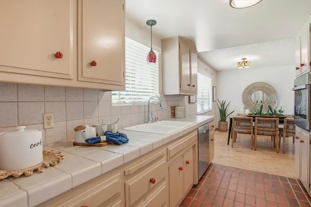 a kitchen with a sink cabinets and appliances