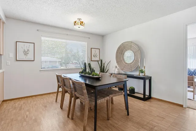 a view of a dining room with furniture and wooden floor
