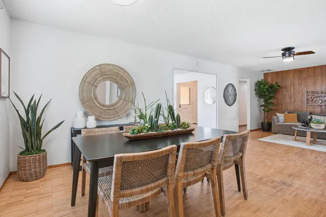 a dining room with furniture and wooden floor