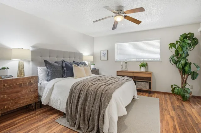 a bedroom with bed and a potted plant