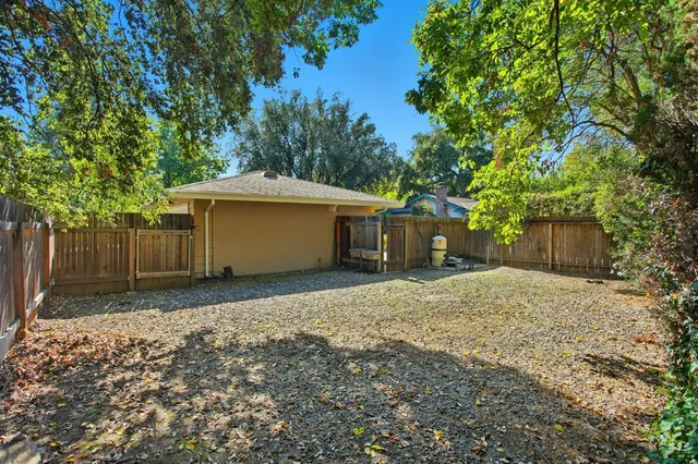 a backyard of a house with a yard and garage