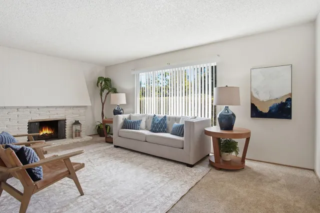 a living room with furniture and a fireplace