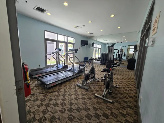 a living room with furniture a flat screen tv and a large window
