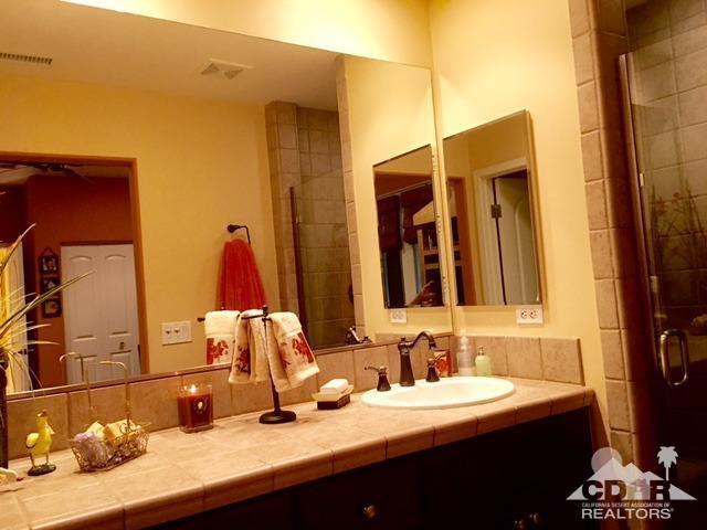 40278 Rancho Palmeras Rancho Mirage, CA 92270 - Photo 27 of 68 a bathroom with a sink and a mirror