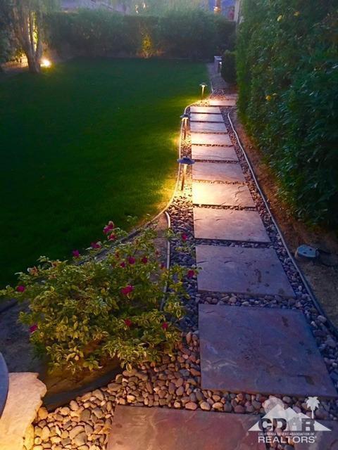 40278 Rancho Palmeras Rancho Mirage, CA 92270 - Photo 57 of 68 a front view of a house with a yard and a garage