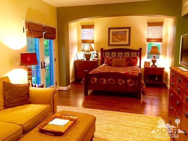 40278 Rancho Palmeras Rancho Mirage, CA 92270 - Photo 59 of 68 a bedroom with a bed and wooden floor