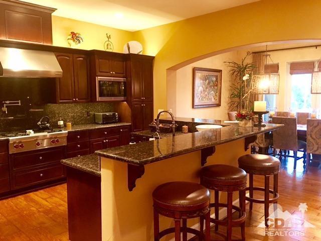 40278 Rancho Palmeras Rancho Mirage, CA 92270 - Photo 6 of 68 a kitchen with a sink and chairs