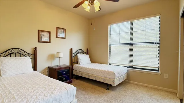 a bedroom with two beds and a window