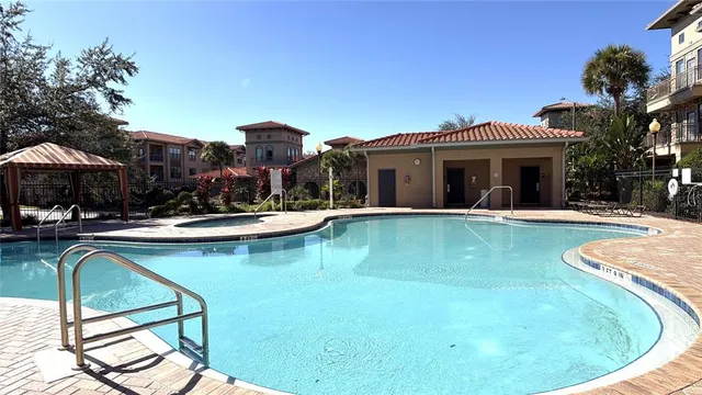 a view of a house with swimming pool and sitting area