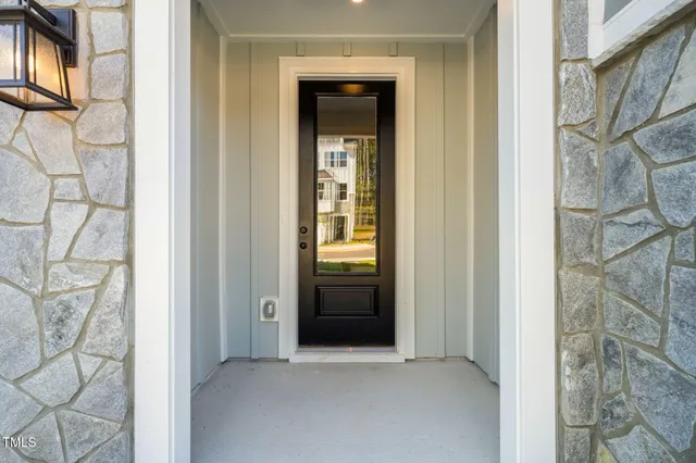 a view of an entryway with wooden floor and door