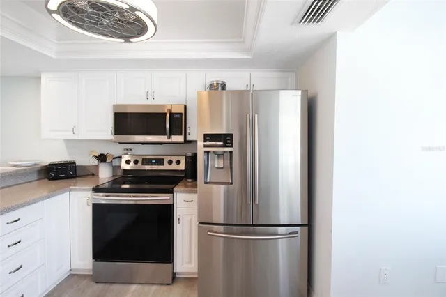 a kitchen with stainless steel appliances a refrigerator stove and microwave