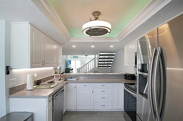 a kitchen with a refrigerator and a sink